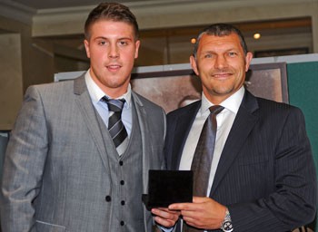 Tom Lineham receives the Rookie award from Barrie McDermott