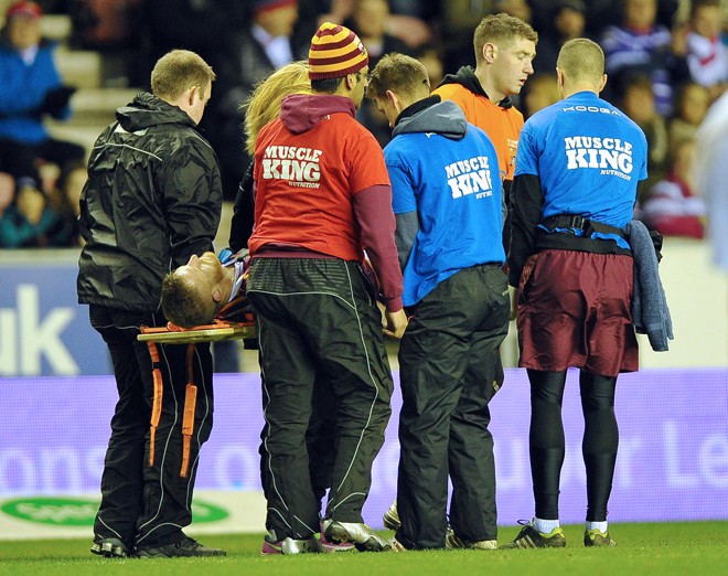 Larne Patrick getting stretchered off against Wigan. ©RLPhotos